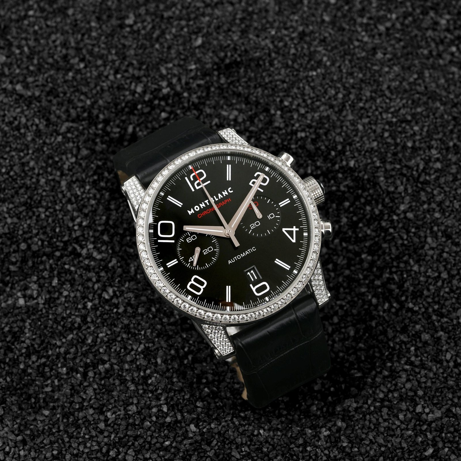 pexels-photo-13273980-13273980-1 High-end chronograph wristwatch with leather strap displayed on a textured surface.