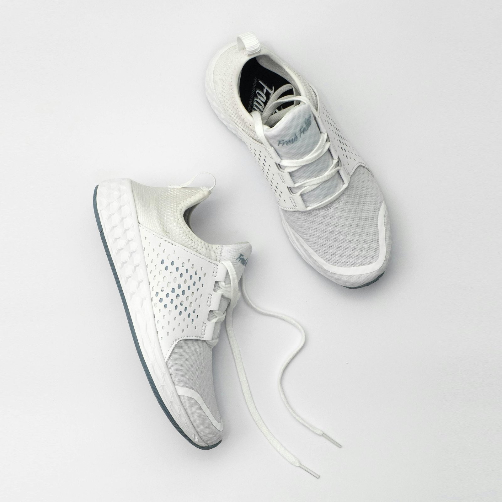 pexels-photo-1464625-1464625 Pair of modern white sneakers with laces on a neutral backdrop.