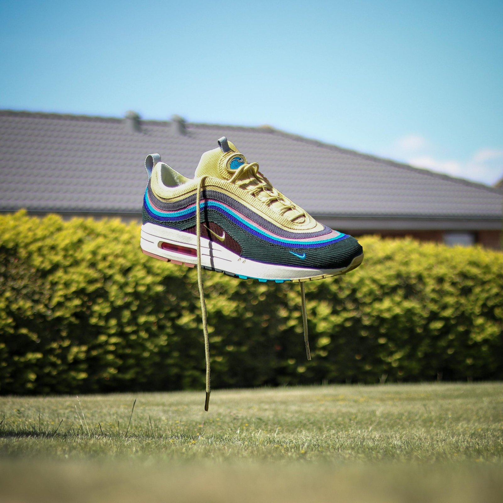 pexels-photo-2404959-2404959 Nike sneaker floating above grass in a sunny Danish garden.
